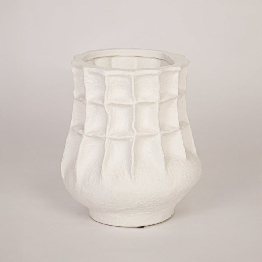 Modern white ceramic flower vase with sculpted pattern isolated on white background for product showcase.