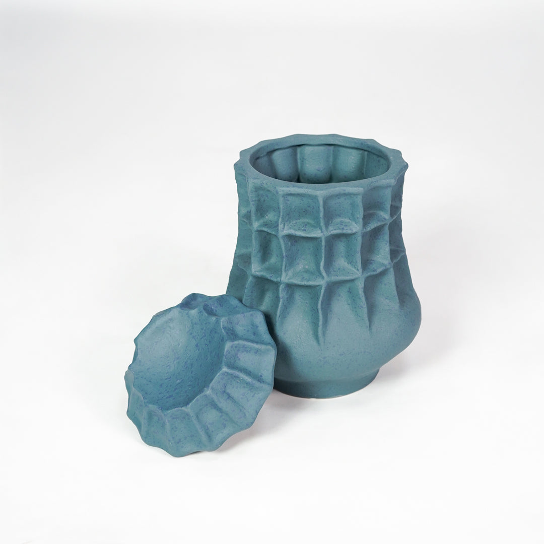 White background image of blue ceramic storage jar for elegant shelf decor styling with textured matte finish.