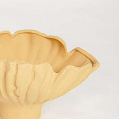 Close view of yellow sagaform ceramic bowl highlighting ruffled edges and smooth matte finish.