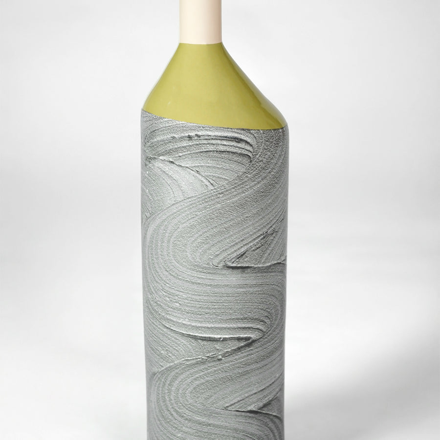 Closeup image of grey ceramic textured bottle vase with gold top for modern console table decor styling display.