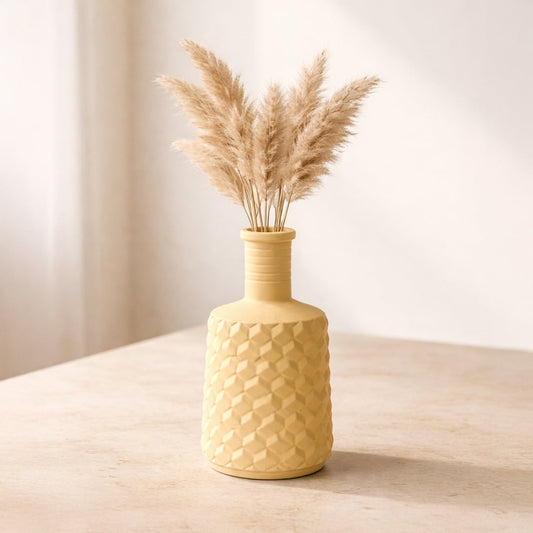 Lifestyle yellow ceramic textured flower vase with dried pampas grass placed on table minimal home decor styling aesthetic interior setup.