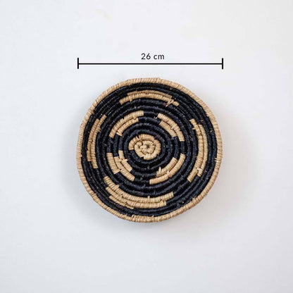 Handwoven seagrass round wall basket decor in natural beige and black with spiral woven design and size guide.
