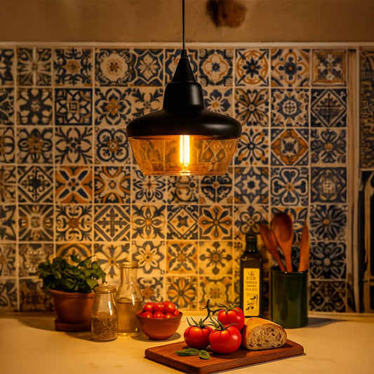 Modern black and amber glass pendant light adding warm glow to kitchen interiors with stylish wall tile backdrop.