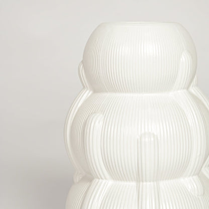 Close view of Samana ribbed white ceramic vase highlighting layered curved form and vertical textured detailing.