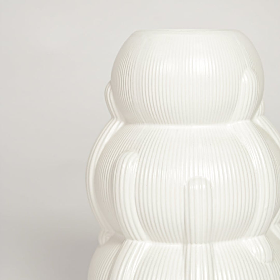 Close view of Samana ribbed white ceramic vase highlighting layered curved form and vertical textured detailing.