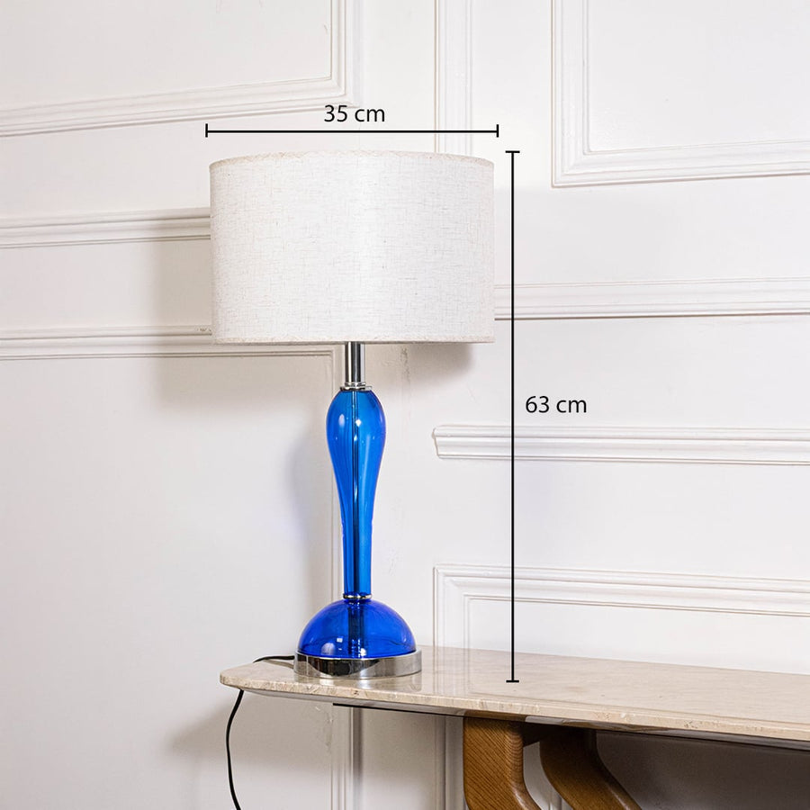 Blue glass lamp with measurements 63 cm height and 35 cm shade width showing elegant design on white background.