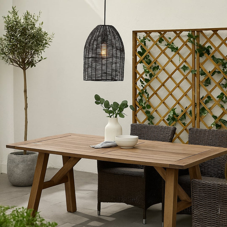Black rattan pendant light adding a modern organic accent to home interiors with elegant weaving and warm ambient illumination.