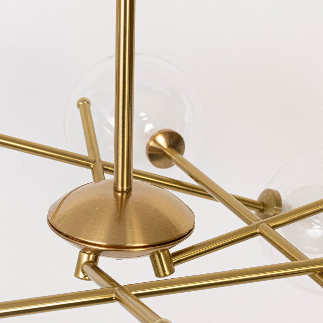 Gold metal chandelier with clear glass globe shades showcasing premium craftsmanship and contemporary lighting design.