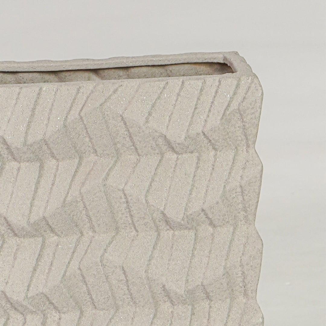 Beige ceramic decorative vase closeup with textured finish modern flower vase for shelf console styling.