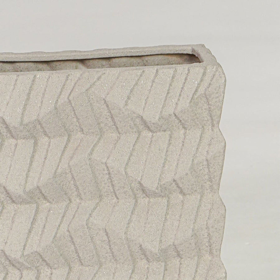 Beige ceramic decorative vase closeup with textured finish modern flower vase for shelf console styling.