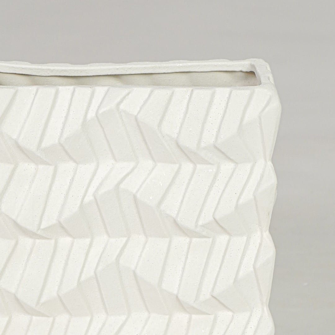 White ceramic decorative vase closeup with textured pattern modern flower vase for shelf console decor styling.