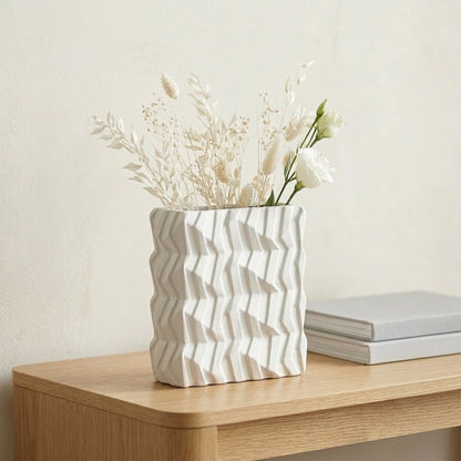 White ceramic decorative vase placed on wooden table modern flower vase for living room shelf decor styling.