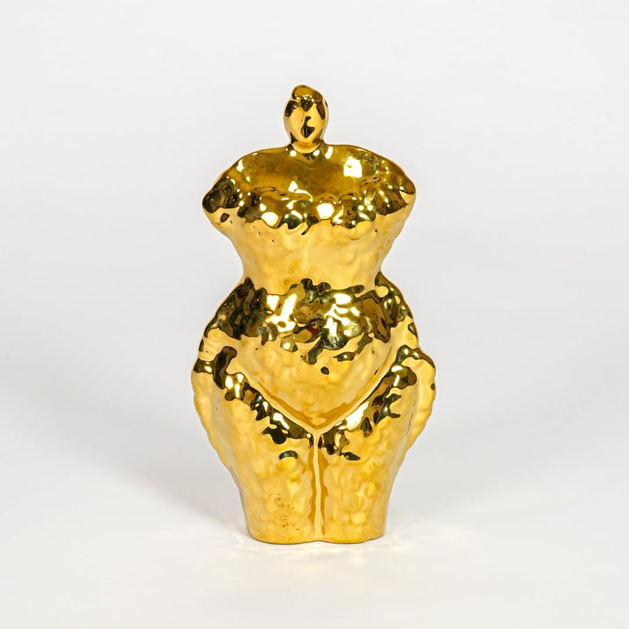 Gold decorative ceramic female sculpture on white background modern home decor accent piece for table shelf console styling.