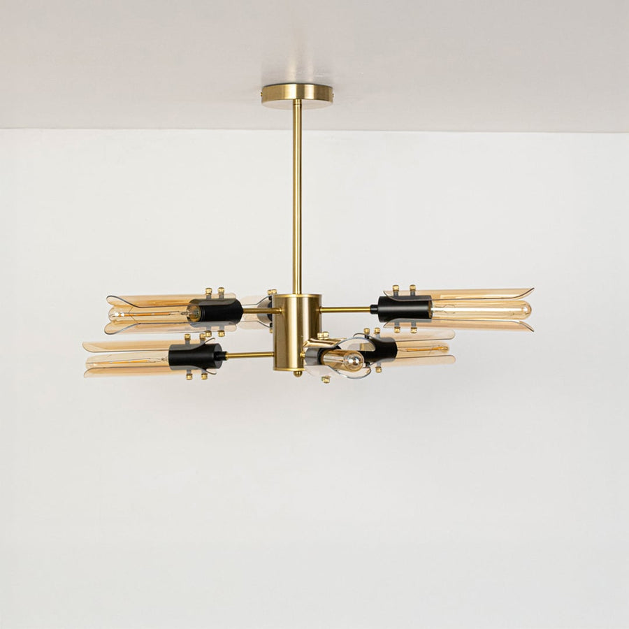 Black metal chandelier with smoky grey glass tubes displayed off on white background showcasing sleek modern lighting design.
