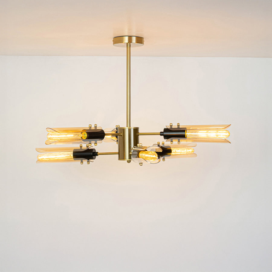 Gold metal chandelier with illuminated crystal tube shades offering luxurious contemporary ceiling lighting design.