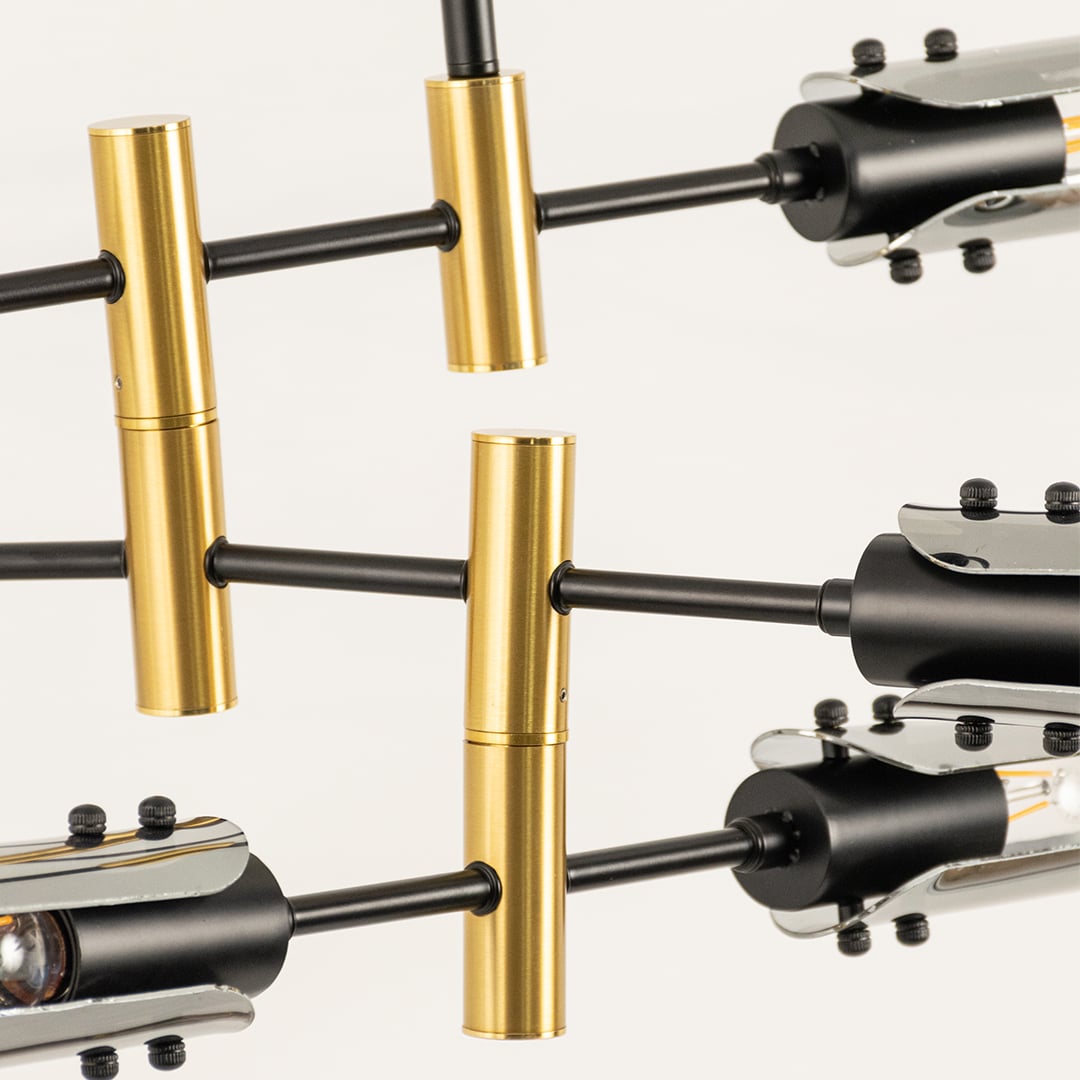 Close view of black and gold chandelier showing smooth glass texture polished metal structure and precise craftsmanship details.