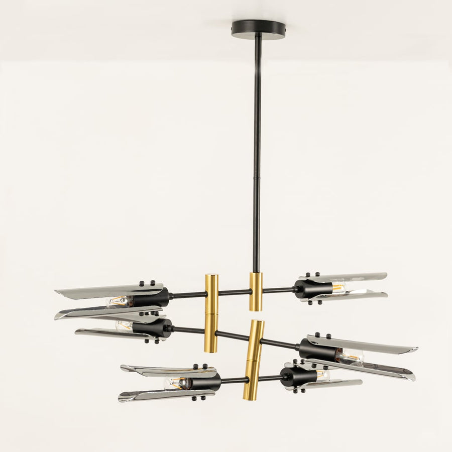 Black and gold chandelier displayed on white background with light off showing sleek design artistic balance and refined finish.