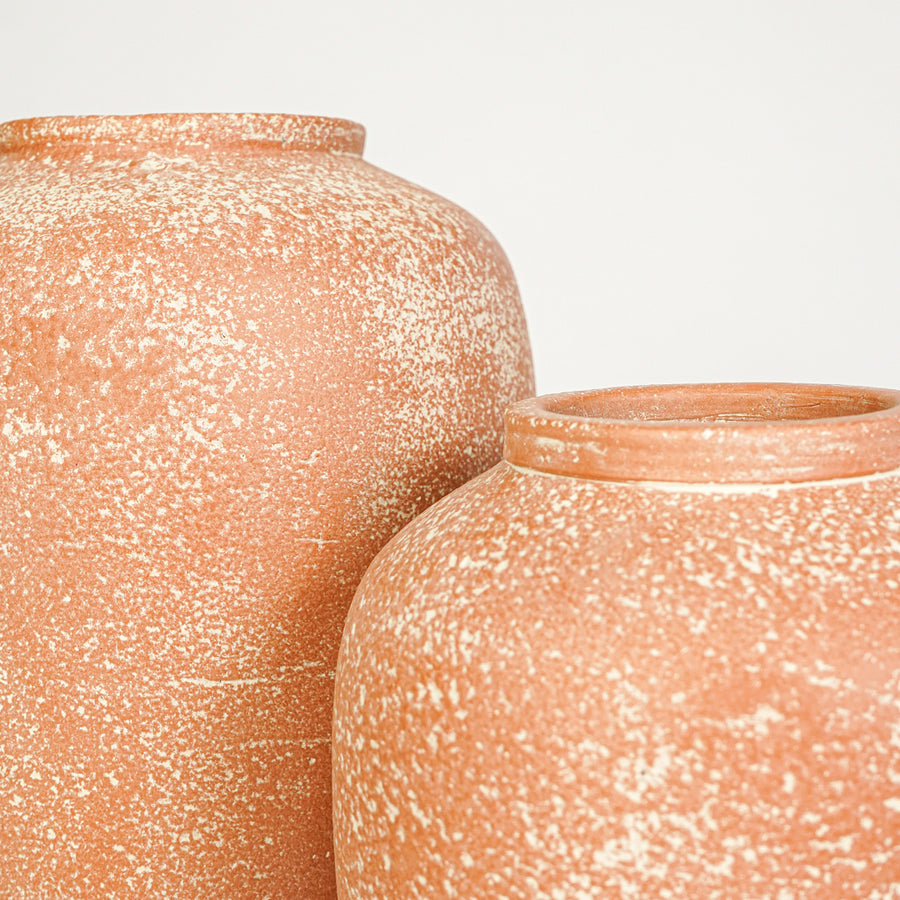 Closeup image of peach ceramic decorative vase set for modern interior styling with rustic textured finish.