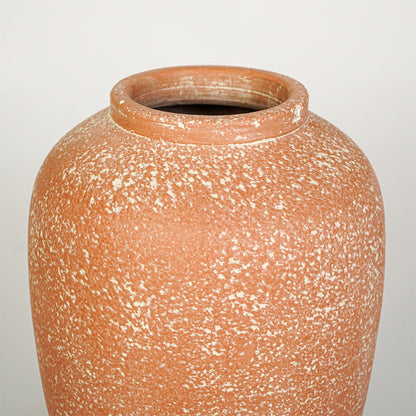 Closeup image of peach ceramic decorative vase for modern tabletop decor styling with textured matte finish.