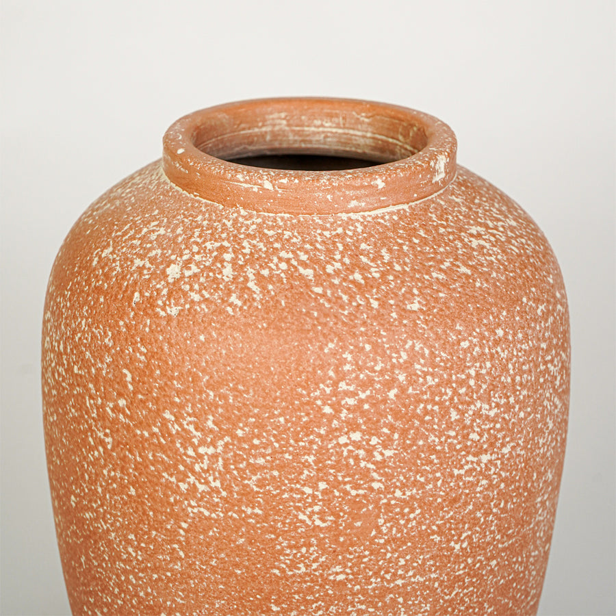 Closeup image of peach ceramic decorative vase for modern tabletop decor styling with textured matte finish.