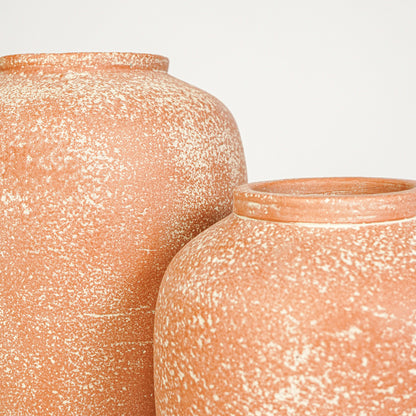 Closeup image of peach ceramic decorative vase set for modern interior styling with rustic textured finish.