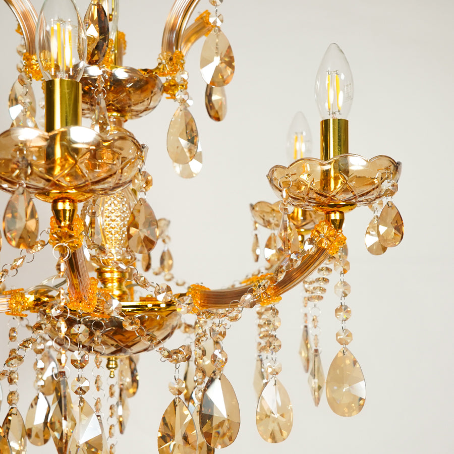 Closeup image of classic clear crystal chandelier for luxury living room decor styling with elegant polished metal finish.