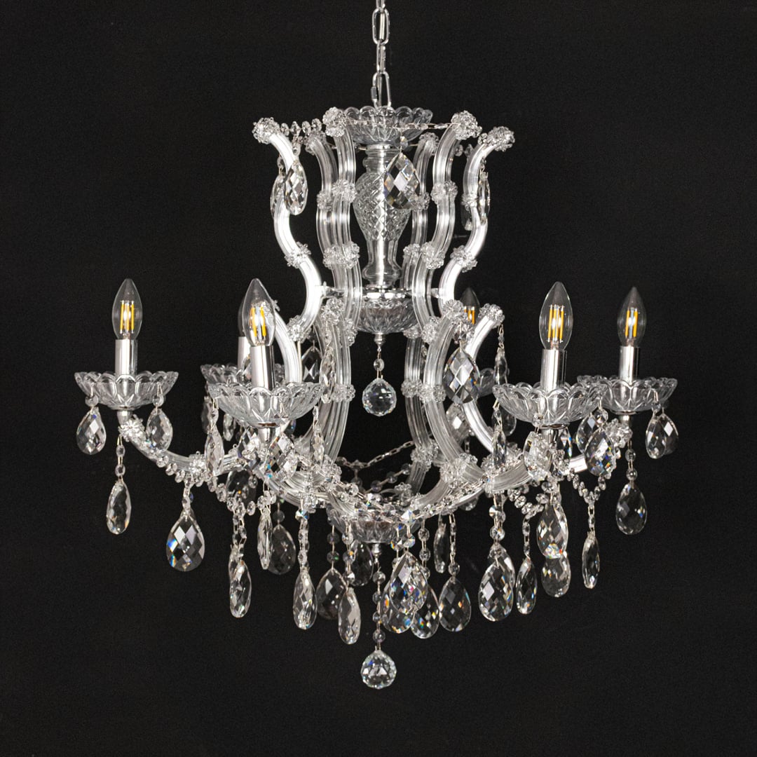 Chrome crystal chandelier with intricate glass arms and droplets displayed on black background for a dramatic decor look.
