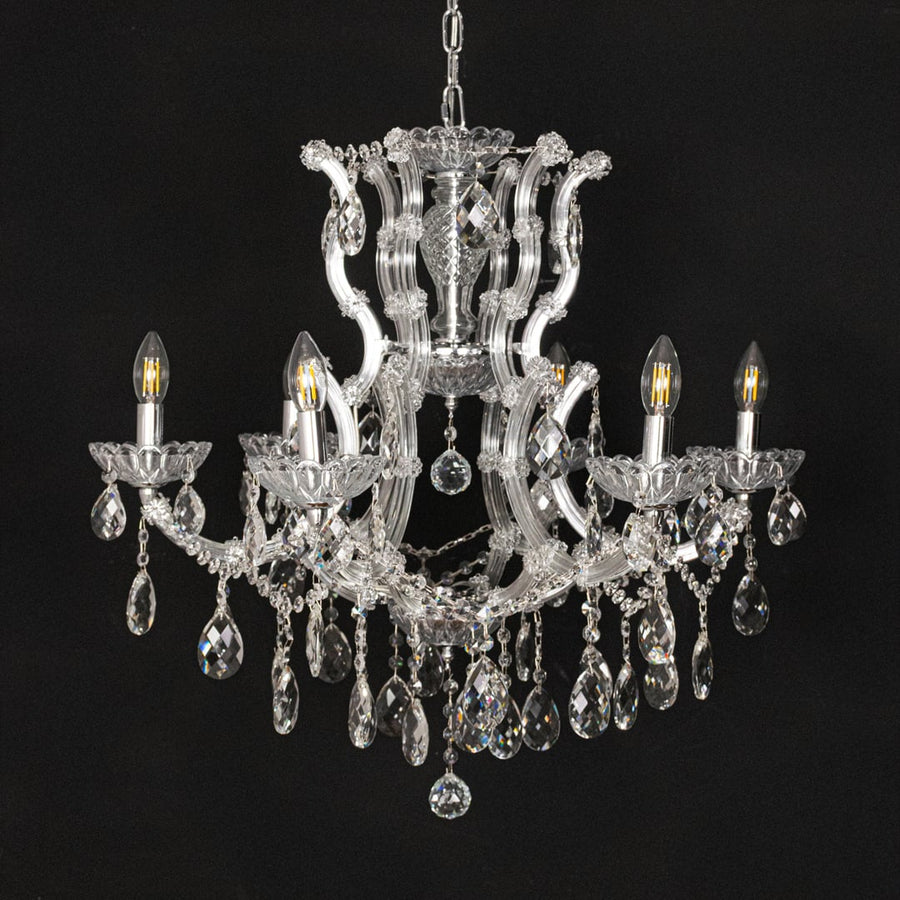 Chrome crystal chandelier with intricate glass arms and droplets displayed on black background for a dramatic decor look.