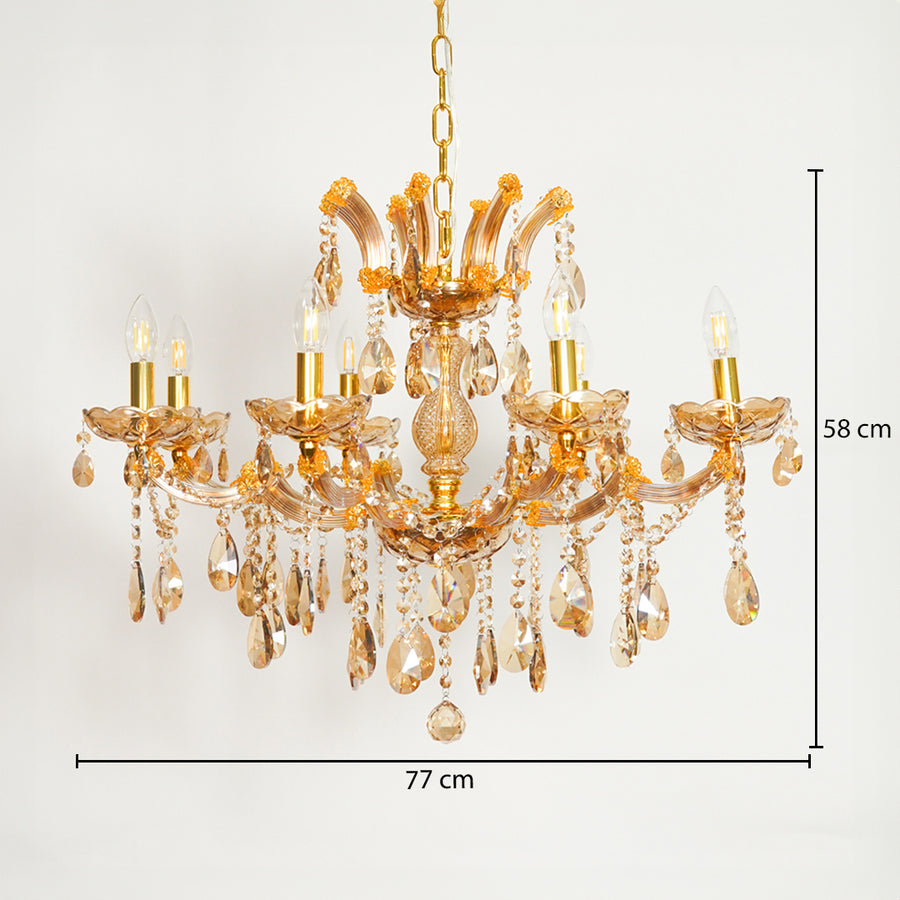 A gold-finished multi-light chandelier with clear glass teardrop crystals, shown against a plain white background with dimension lines indicating 77 cm width and 58 cm height.