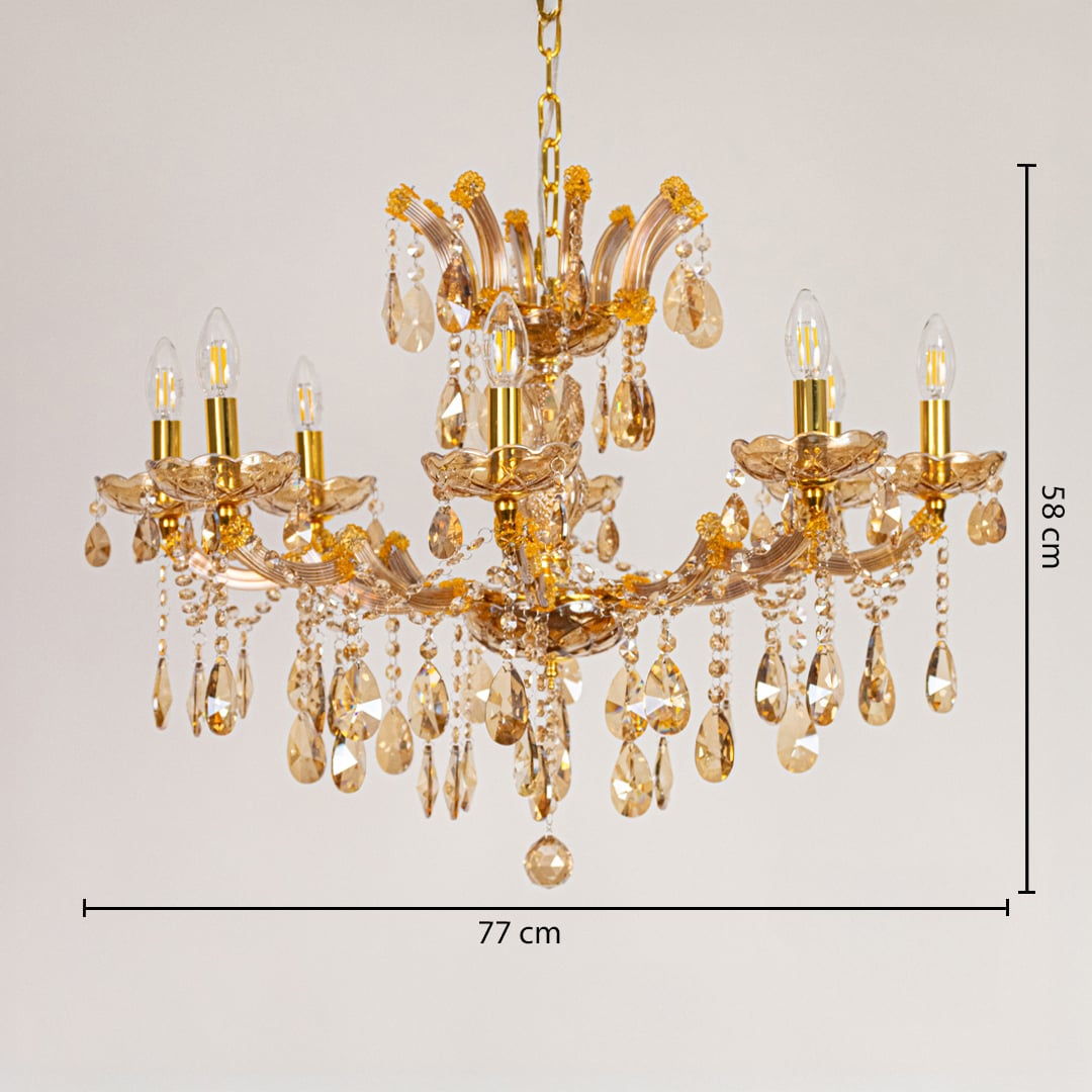 Gold crystal chandelier measuring 77 cm wide and 58 cm tall with ornate drops ideal for living and dining lighting.