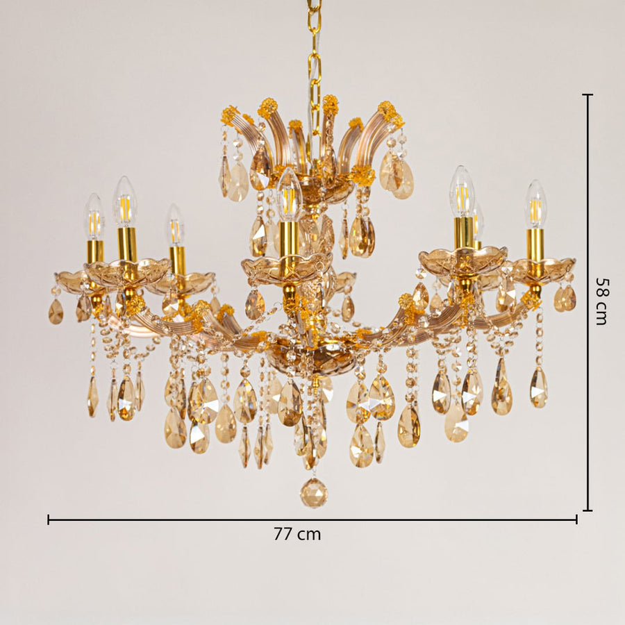 Gold crystal chandelier measuring 77 cm wide and 58 cm tall with ornate drops ideal for living and dining lighting.