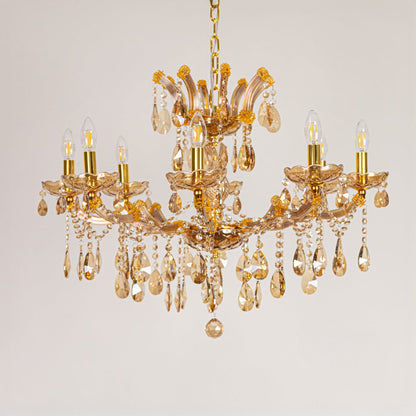 Gold crystal chandelier with ornate crystal arms shown on a white background for premium home decor inspiration.