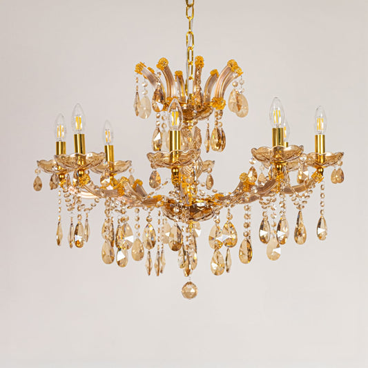 Gold crystal chandelier with ornate crystal arms shown on a white background for premium home decor inspiration.