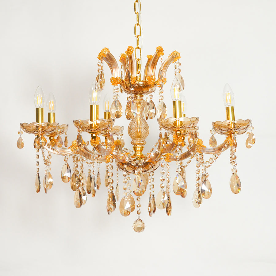 A five-light crystal chandelier with a gold-finished metal frame and clear glass teardrop pendants, shown against a plain white background.