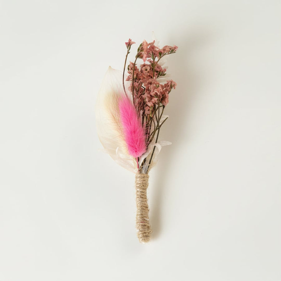 Dried floral stem bouquet with soft pink dried blossoms feather accent and neutral tones on white background highlighting delicate texture and handcrafted decor appeal.
