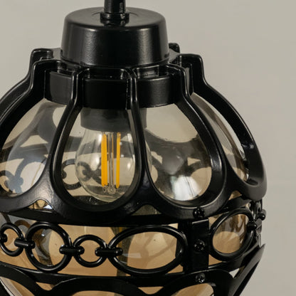 Close up view of the decorative metal rings and inner glass globe of the black spherical cage pendant light fixture.