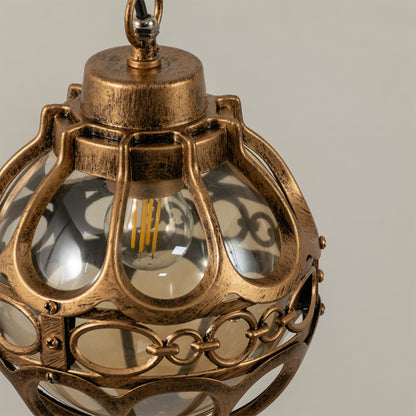Close up view of the decorative metal rings and inner glass globe of the black spherical cage pendant light fixture.