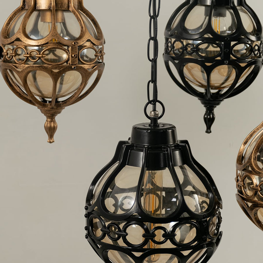 Detailed look at the top finial and chain suspension of the antique brass finish round globe outdoor hanging lantern.