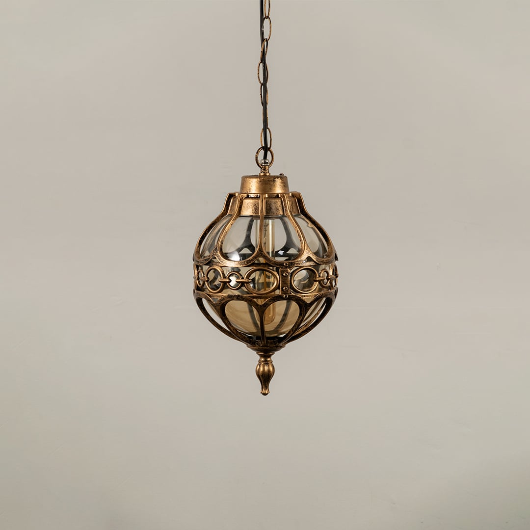 Unlit black metal globe hanging light fixture with decorative circular pattern cage isolated against a plain white background.