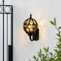 Decorative black metal outdoor wall light for porch entrance balcony and exterior walls with warm ambient lighting.