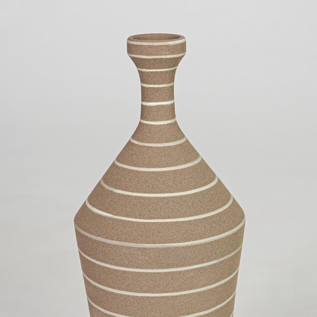 Closeup brown striped ceramic vase texture detail modern decorative flower vase for table shelf console decor.