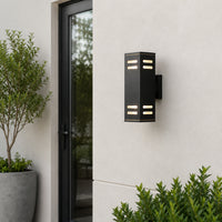 Black metal outdoor LED wall light with slatted design for porch entrance garden and exterior walls with warm lighting.