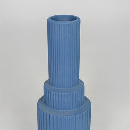 Closeup blue ribbed ceramic vase texture detail modern decorative flower vase for table shelf console decor.