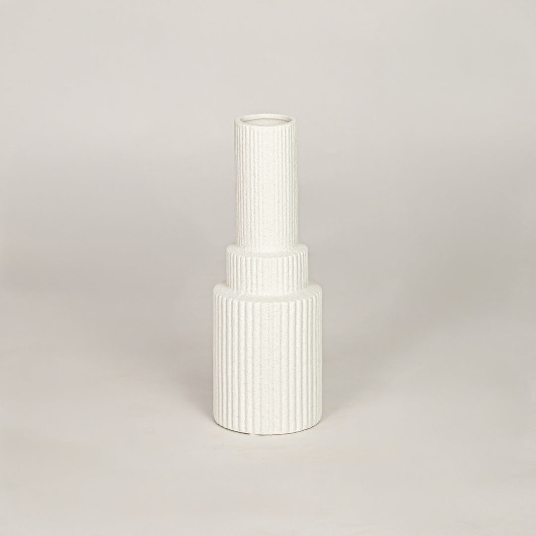 Tall white minimalist architectural vase with ribbed base for modern home decor and clean interior shelf styling needs.