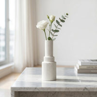 White ceramic flower vase with ribbed texture styled with fresh blooms for elegant modern home decor.