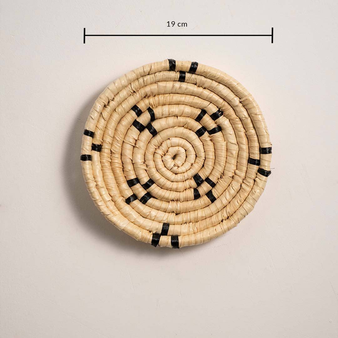 Dimension image of handcrafted natural cream seagrass wall basket with small black block patterns for boho wall decor.