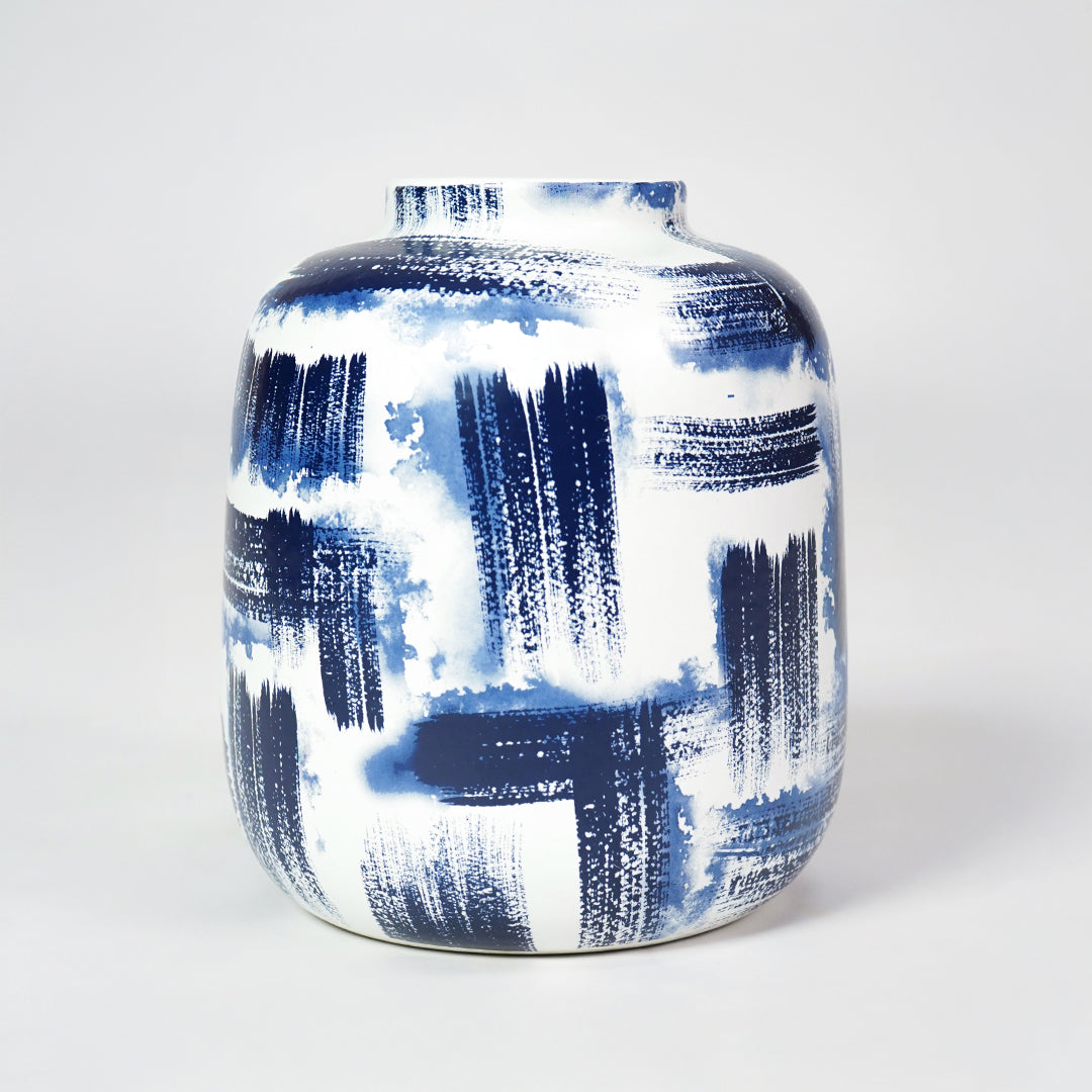 White ceramic rounded vase with bold blue brushstroke pattern for stylish modern home decor and accent display.