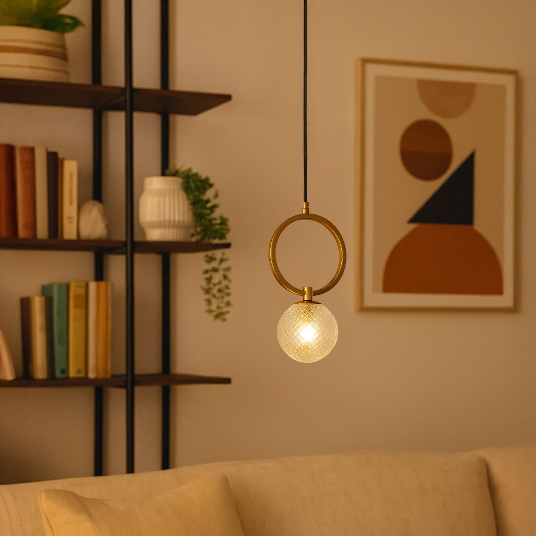 Gold ring pendant light with textured glass globe styled in a modern interior adding warm elegant illumination to home decor.