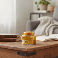 Amber ceramic decorative jar displayed on a wooden coffee table for warm contemporary home decor and tabletop styling.