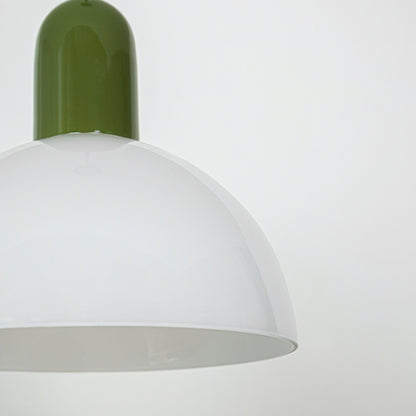 Closeup of pendant light with green metal top and smooth white dome shade showcasing modern design for interior lighting decor.